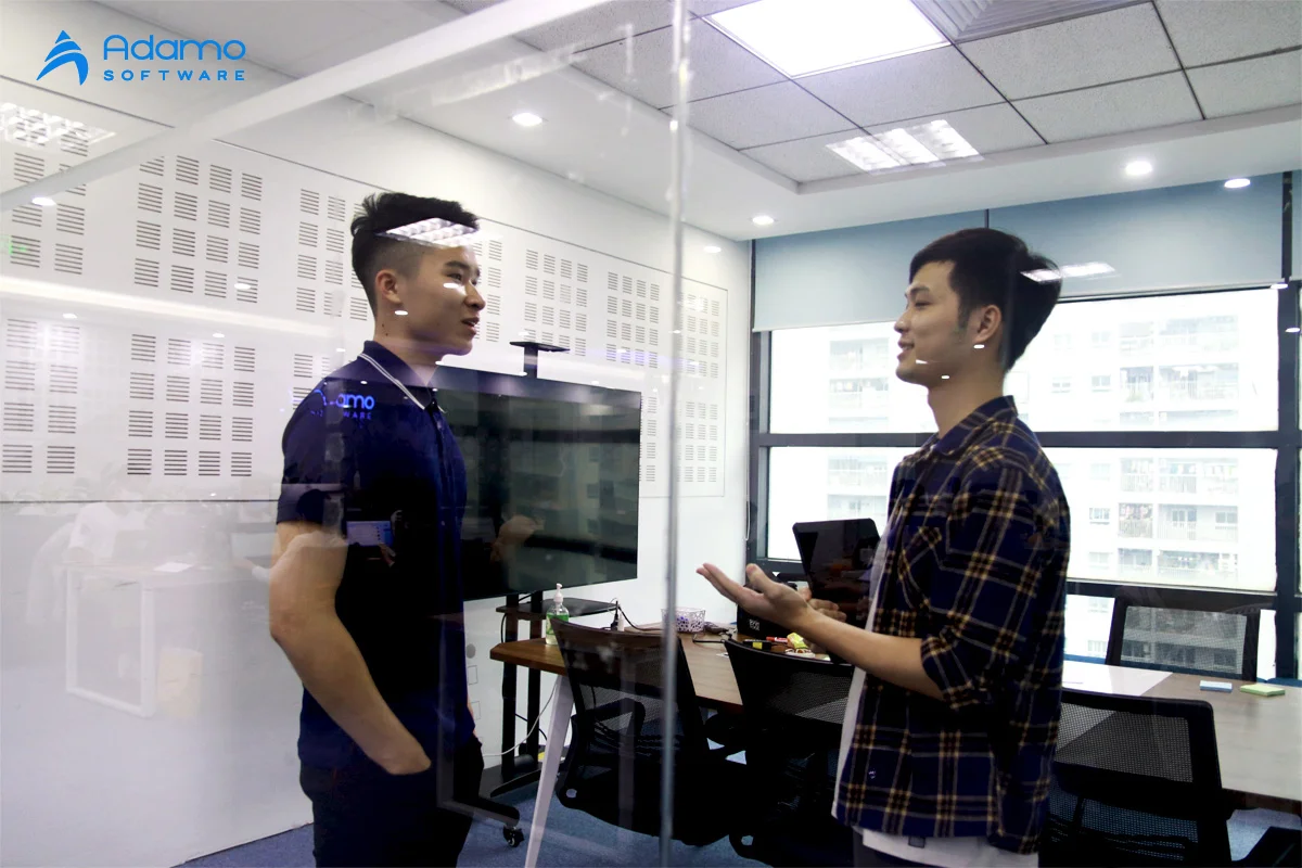 developers-at-IT-outsourcing-company | Adamo Software discussion-between-our-developers